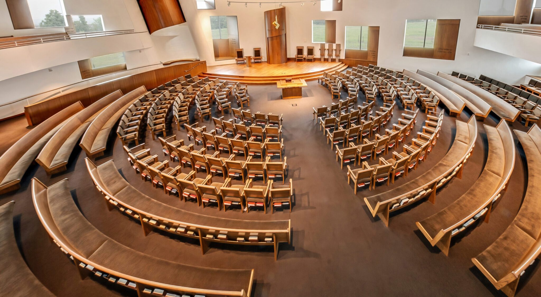 a church sanctuary with curved pews